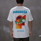 Person wearing a paradaiza white t-shirt with colorful design and text
