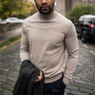 Man wearing a paradaiza beige turtleneck sweater 