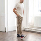 model wears para-daiza tan pinch chinos with converse