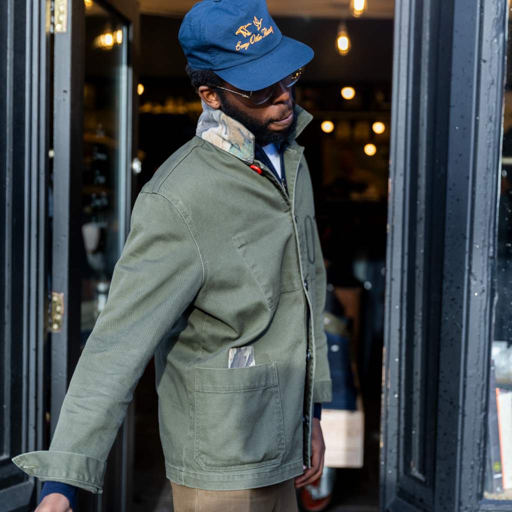 model wearing paradaiza khaki worker jacket out side the paradaiza 