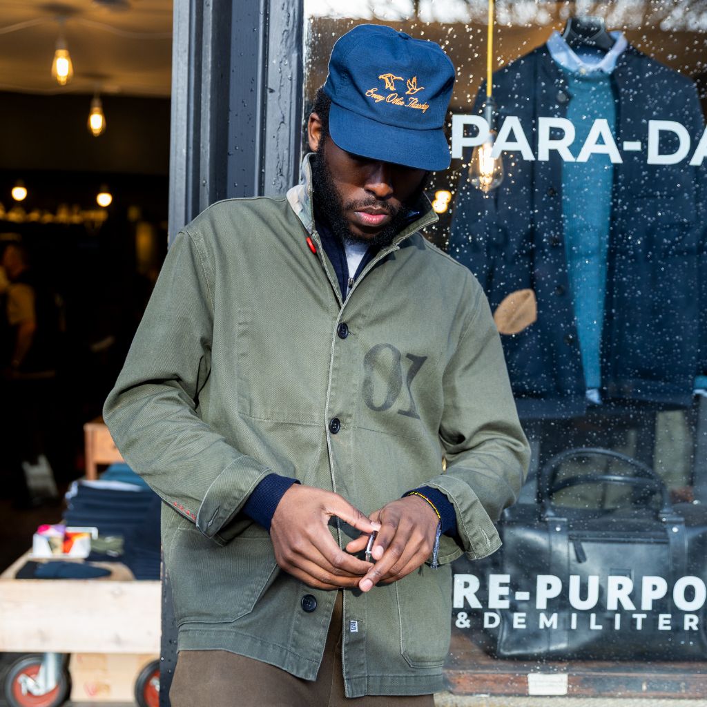 model wearing paradaiza khaki worker jacket out side the paradaiza 