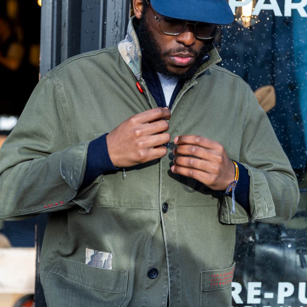 model wearing paradaiza khaki worker jacket out side the paradaiza 