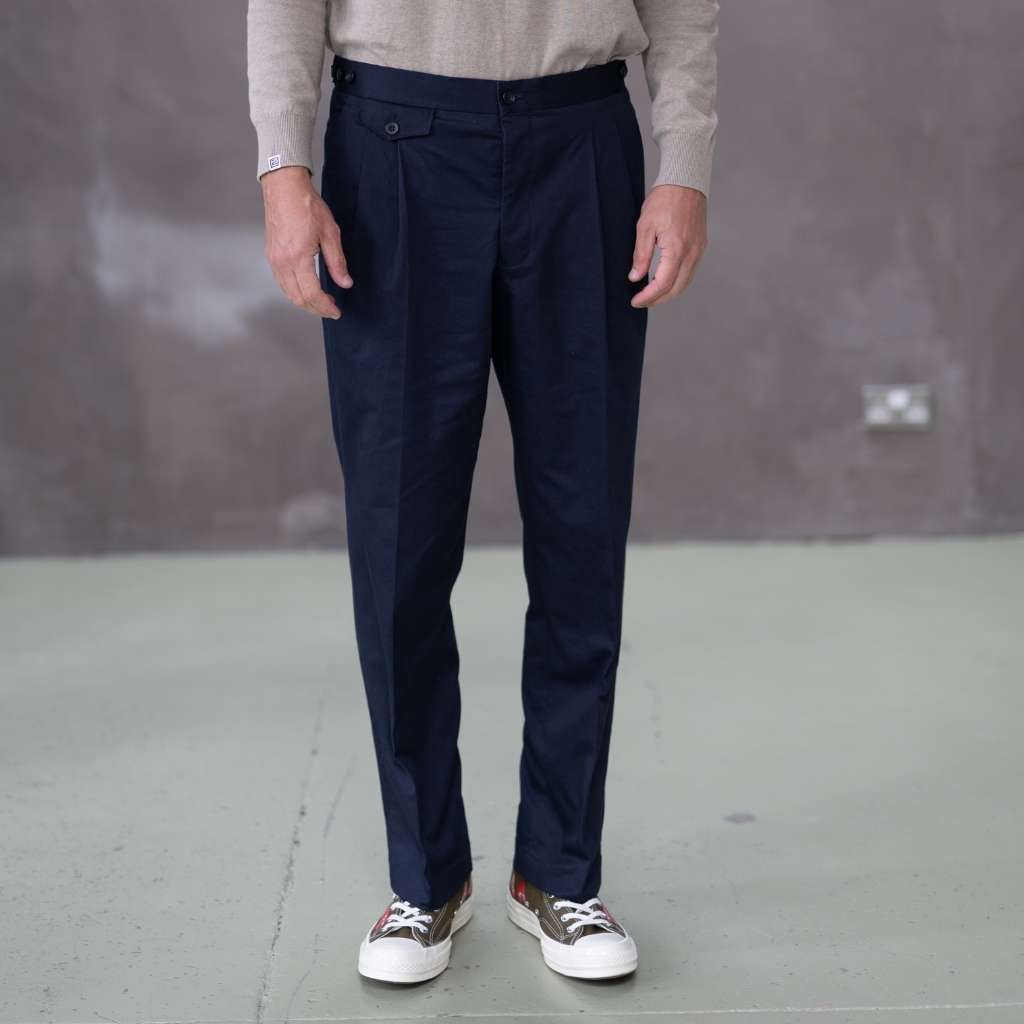 Person wearing paradaiza navy pants with a neutral background