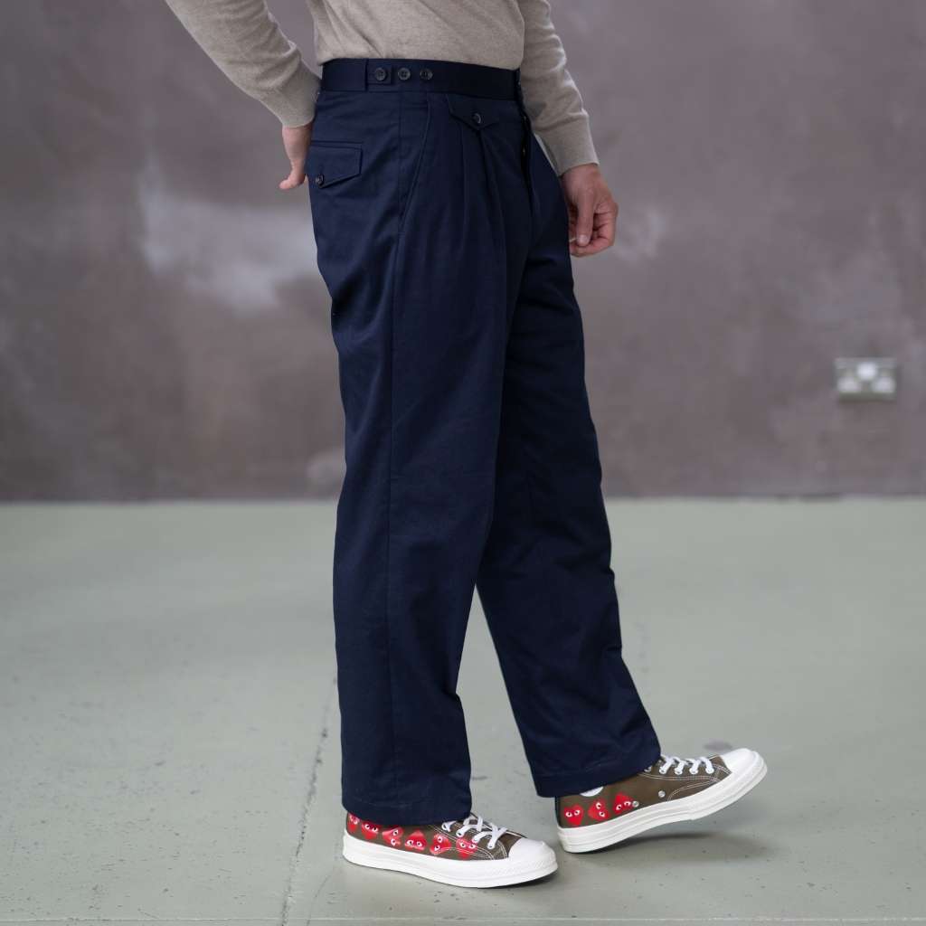 Person wearing paradaiza navy pants with a neutral background