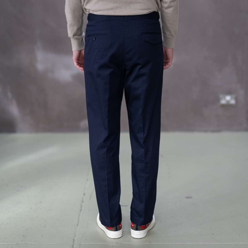 Person wearing paradaiza navy pants with a neutral background