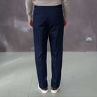 Person wearing paradaiza navy pants with a neutral background