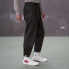 Person wearing paradaiza pinch chinos pants and white sneakers with red and blue designs on a plain background