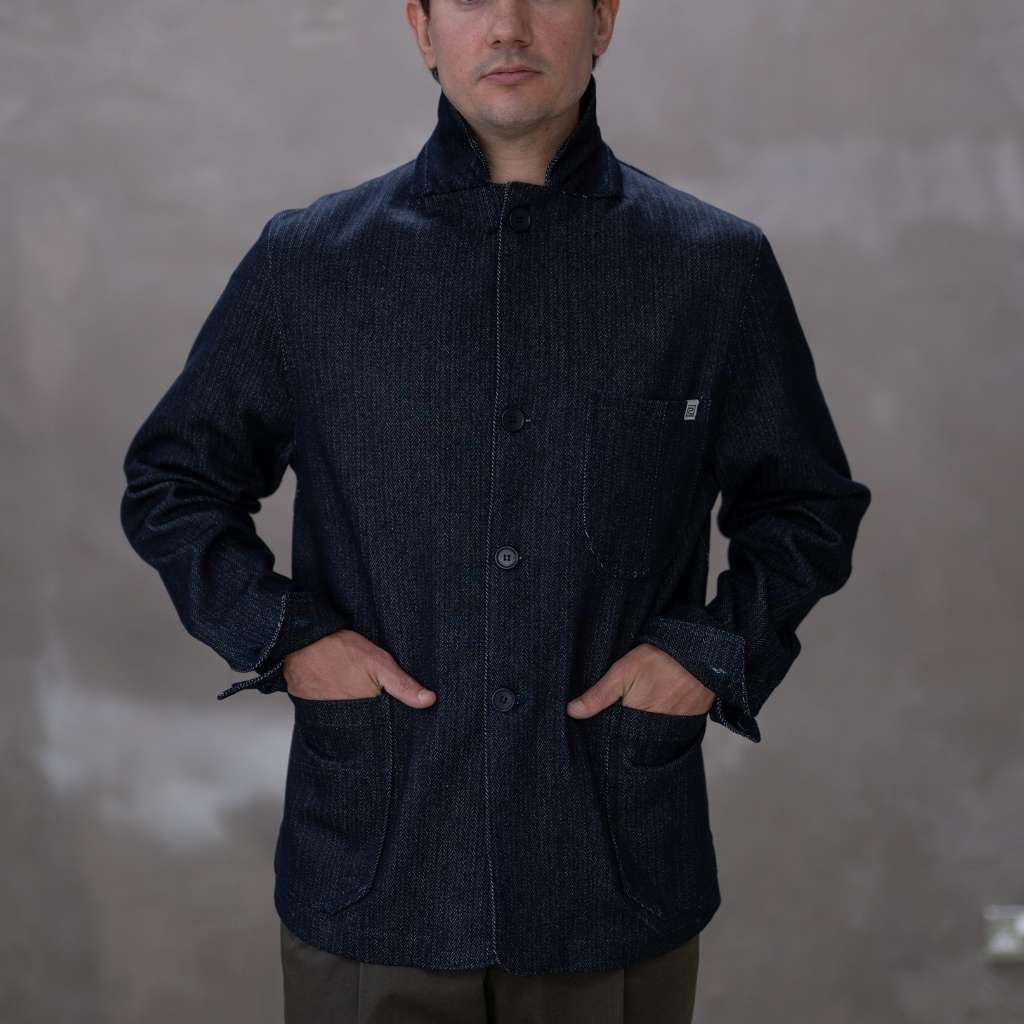 Man wearing a paradaiza dark denim jacket against a plain background