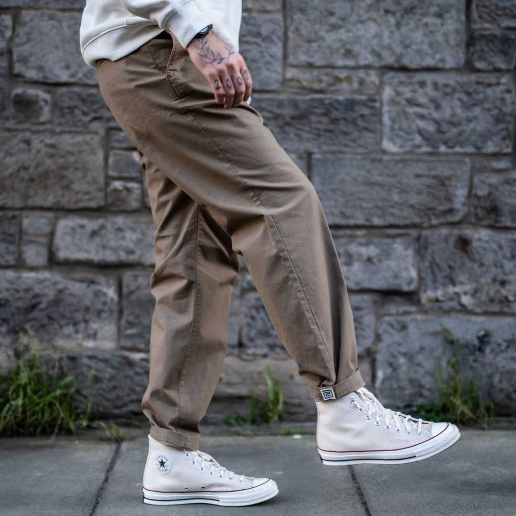 model wears para-daiza tan pinch chinos with converse