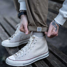 model wears para-daiza tan pinch chinos with converse