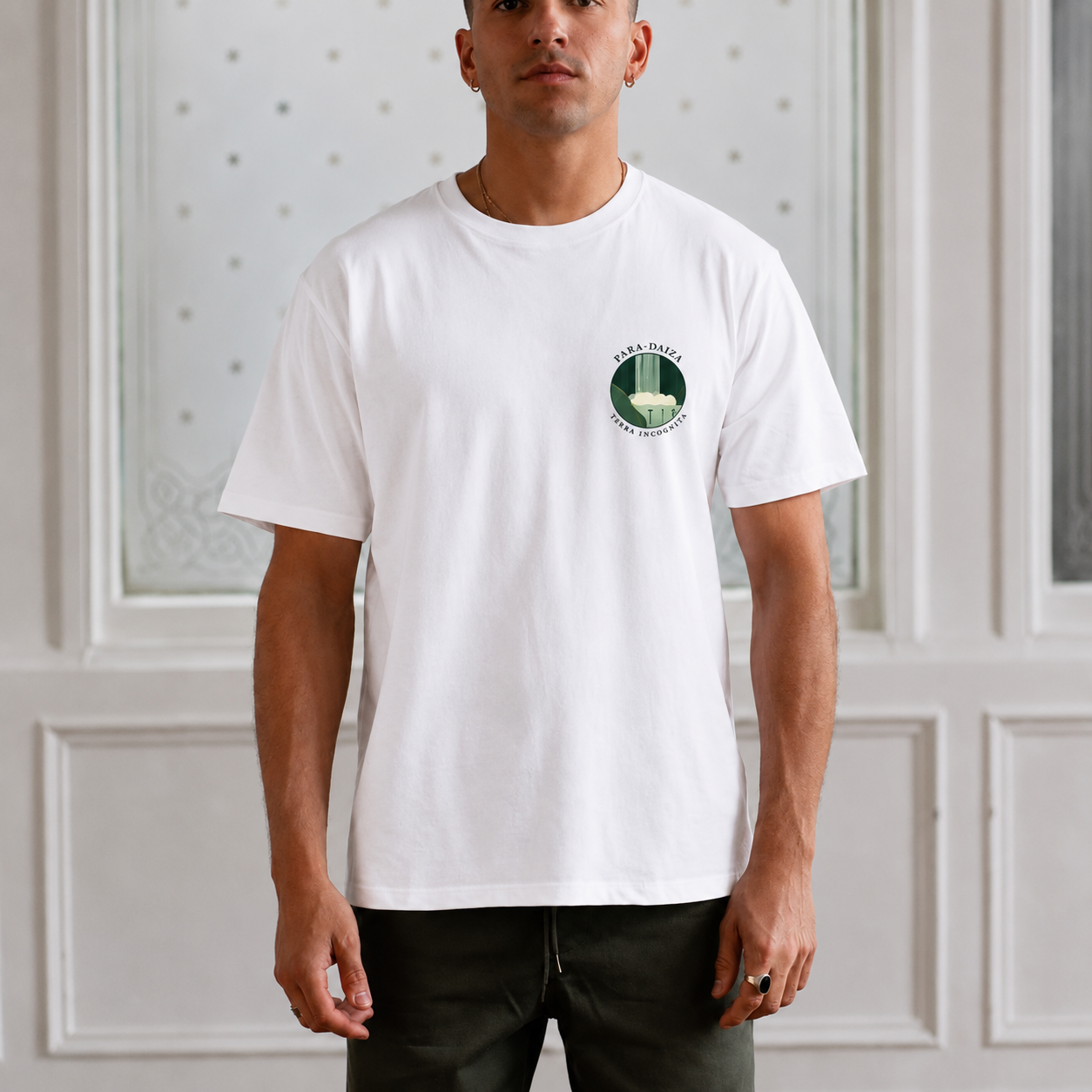 model wearing a white paradaiza tee with terra incognita bage on the chest